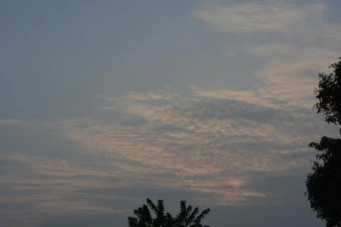 Dramatic clouds in the eastern sky with the sun rises behind it Stock Photos