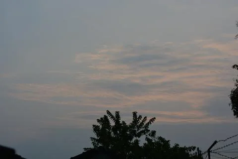 Dramatic clouds in the eastern sky with the sun rises behind it Stock Photos