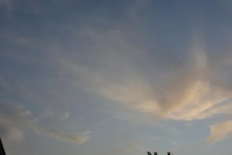 Dramatic clouds in the eastern sky with the sun rises behind it Stock Photos