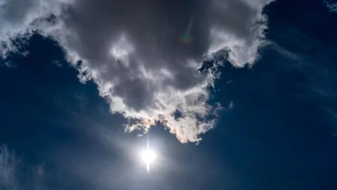Dramatic clouds float across the blue sky Stock Photos