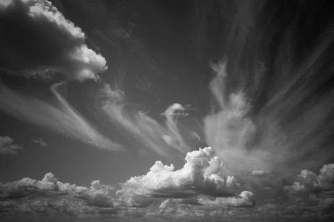Dramatic clouds float across the blue sky Foto stock