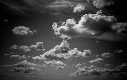 Dramatic clouds float across the blue sky Stock Photos
