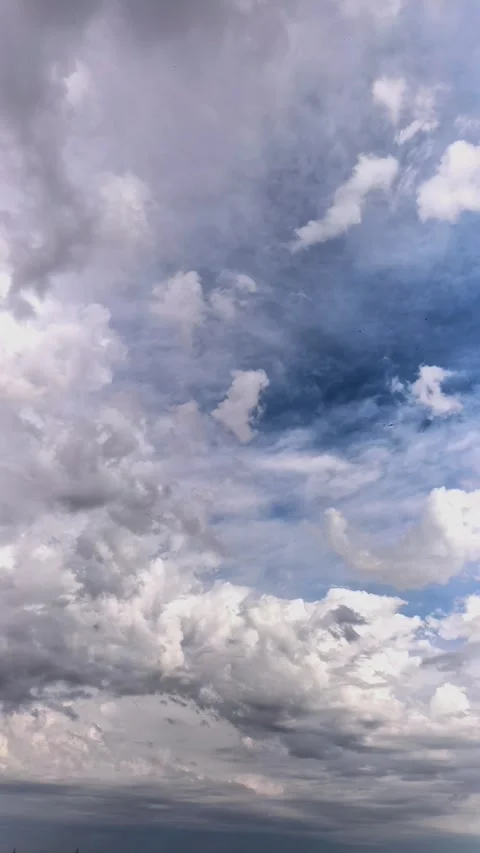 Dramatic clouds form and move across a blue sky in time lapse, atmospheric Stock Footage 339848168
