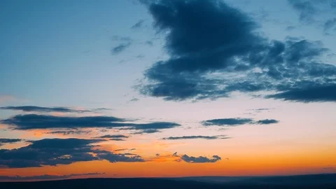 Dramatic clouds formatting storm in bright colors during sunset. Red, orange 스톡 동영상 105157045