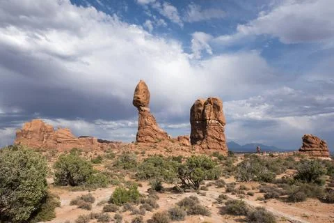 Dramatic clouds frame Balancing Rock in Arches National Park, Moab, UT Stock Photos