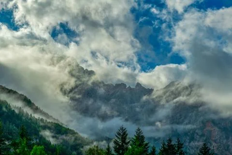 Dramatic clouds in front of mountain Stock Photos
