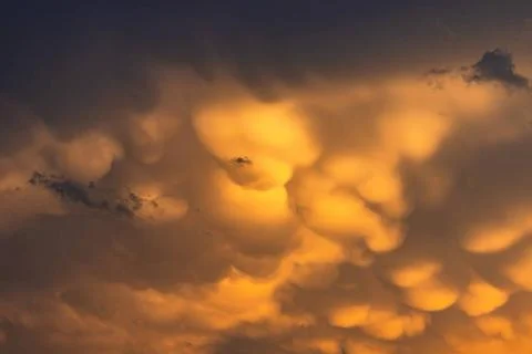 Dramatic clouds in front of yellow glowing sunset Spectacular yellow cloud... 写真素材