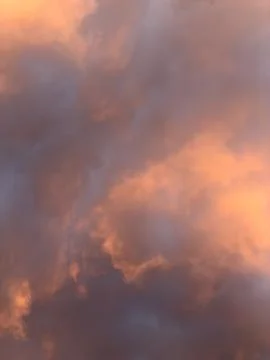 Dramatic clouds glow in warm, golden hues Stock Photos