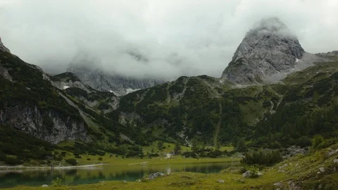 Dramatic clouds hang over a scenic lake Stock Footage 101903122