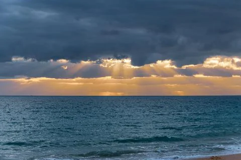 Dramatic clouds illuminated by sunset in Albufeira Stock Photos