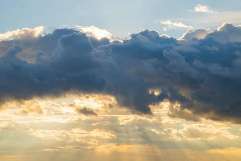 Dramatic clouds illuminated by sunset glow over tranquil sky Stock Photos