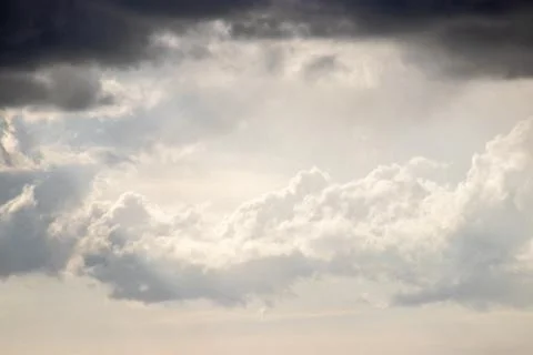 Dramatic clouds with light breaking through, offering hope amid dark skies. Stock Photos