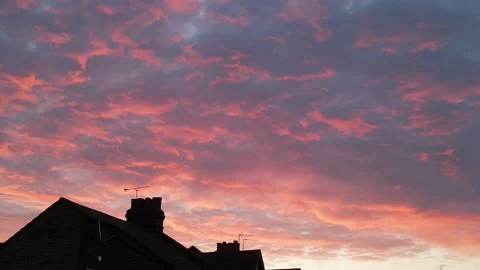 Dramatic clouds lit by the rising sun Vidéo 237718615