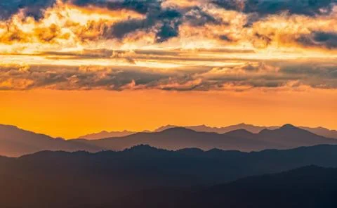 Dramatic clouds with mountain and sunset sky Stock Photos