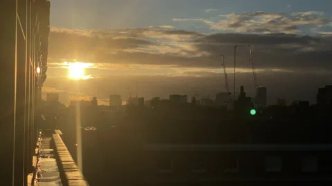 Dramatic clouds move at evening over the rooftops and skyline of London Stock Footage 164575857