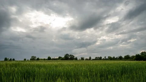 Dramatic clouds moving across a field Stock Footage 132216776