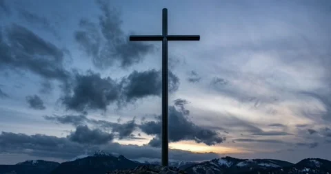 Dramatic Clouds moving behind christian cross in mountains nature heaven Time Stock Footage 277797406