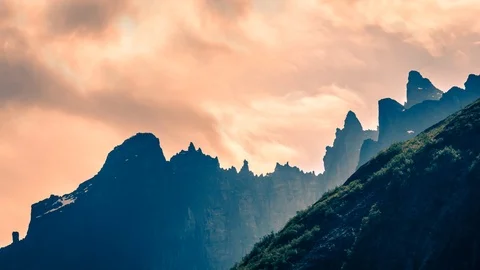 Dramatic clouds moving behind mountains cinemagraph Stock Footage 100774163