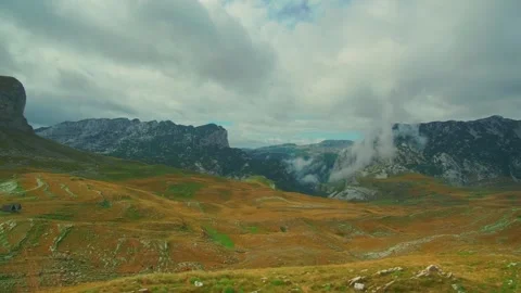 Dramatic clouds moving over grassy mountain valley in Durmitor Montenegro 動画素材 342799752