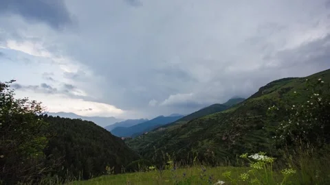 Dramatic clouds moving over green valley timelapse in Coll De La Creueta, B.. Stock Footage 297623883