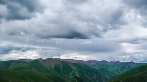 Dramatic Clouds Moving Over Lush Green Mountain Peaks During A Summer Afternoon Stock Footage 342230175
