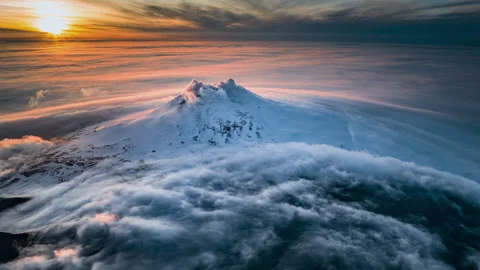 Dramatic clouds moving over smoking volcano at sunset Видео 335498586
