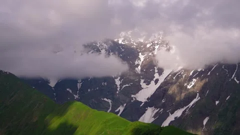 Dramatic clouds moving over snow-capped mountains Stock Footage 347402020