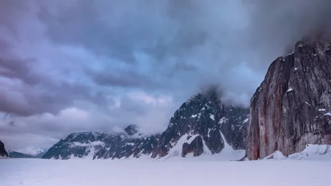 Dramatic clouds moving over snowy mountain range Stock Footage 335104883