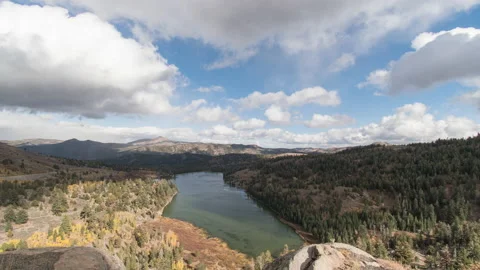 Dramatic clouds over alpine lake in mountain range and valley, timelapse Stock Footage 221538061