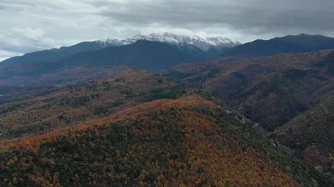 Dramatic Clouds Over Autumnal Landscape with Snowy Mountains 스톡 동영상 333722273