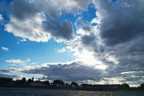 Dramatic Clouds over Blue Sky at British City of England UK Weather Stock Photos
