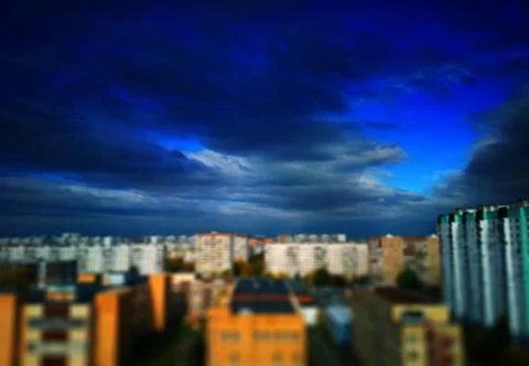 Dramatic clouds over blurred abstract city background Stock-Fotos