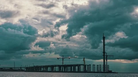 Dramatic Clouds over a Bridge Under Construction, timelapse Stock Footage 54353520