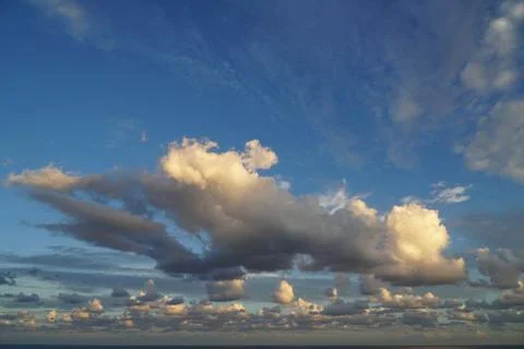 Dramatic clouds over a calm ocean Stock Photos