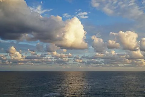 Dramatic clouds over a calm ocean Stock Photos
