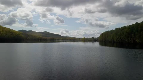 Dramatic Clouds Over Calm Reservoir and Forested Hills 스톡 동영상 337226918