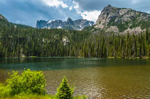 Dramatic clouds over fern lake with gabletop, knobtop and notchtop mountain p Stock Photos