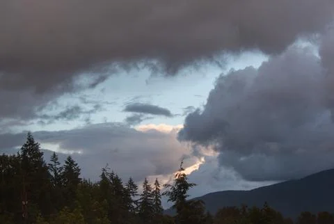 Dramatic clouds over the forests and mountains of Washington Stock Photos