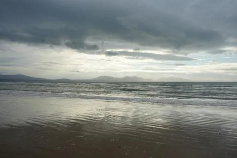 Dramatic Clouds Over Llanddwyn Beach, Anglesey, North Wales With Waves And Stock Photos