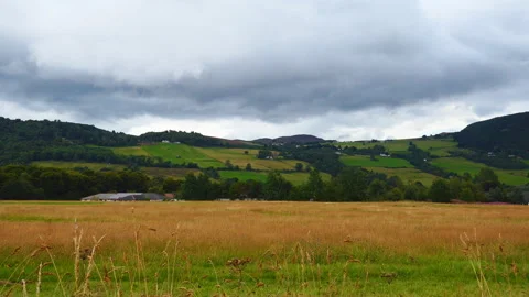 Dramatic clouds over meadows and fields. Scotland. Stock Footage 90028131