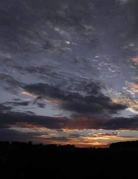Dramatic Clouds Over a Moody Sunset Horizon Stock Photos
