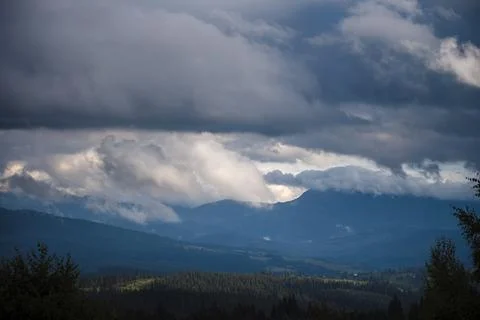 Dramatic Clouds Over Mountain Landscape Stock Photos