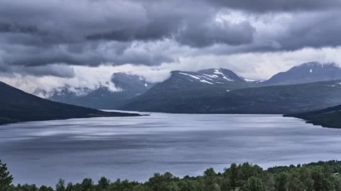 Dramatic Clouds Over Oppdal Lake and Mountains Transition From Evening to Night Stock Footage 315074048