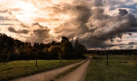 Dramatic clouds over pastures Stock Photos