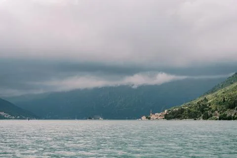 Dramatic clouds over Perast and Bay of Kotor coastline Фото