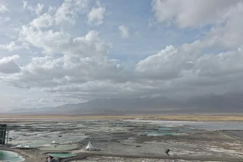 Dramatic Clouds Over a Pool-Dotted Salt Flat Stock Photos