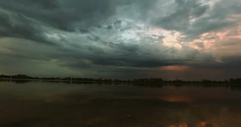 Dramatic clouds over the river sunset timelapse Stock-Footage 129497302