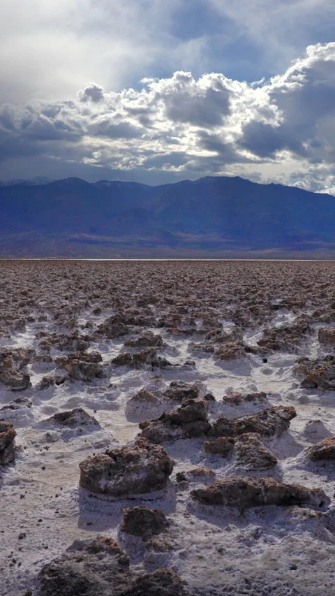 Dramatic Clouds Over Salt Flat Desert with Distant Mountain Range. Video stock 342942664