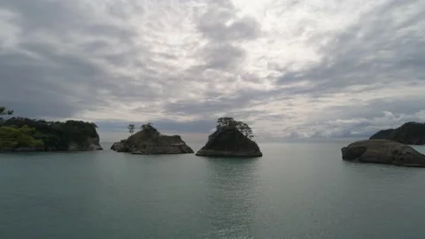 Dramatic clouds over sea stacks in the sea in Izu Peninsula, Shizuoka Stock Footage 194407707