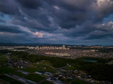 Dramatic clouds over small suburban development at dusk Stock Photos